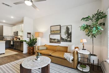 A living room with a yellow couch and a white coffee table at Arcadia Cartersville Apartments, Cartersville